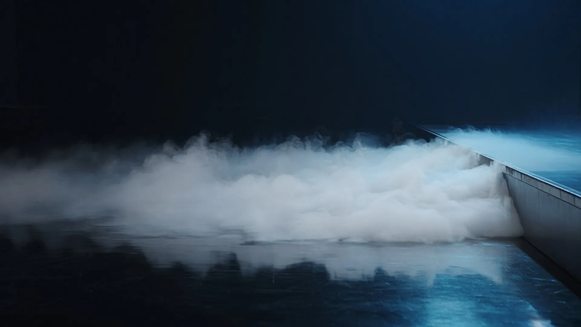 Low white fog hugging a polished stage floor