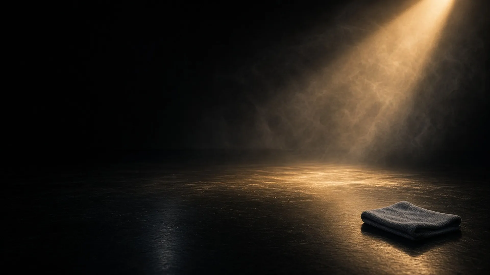 A polished black stage floor with a faint sheen