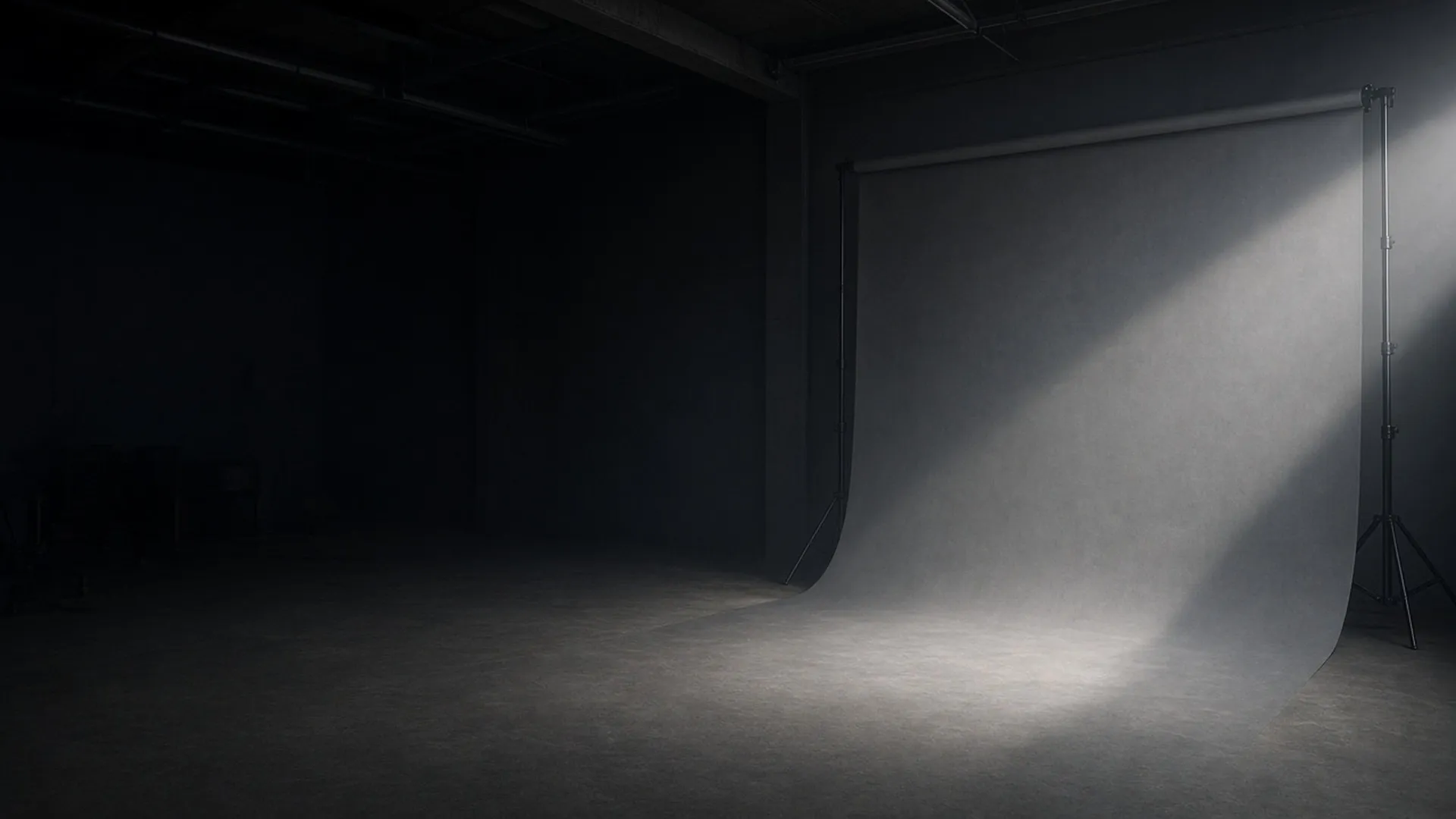 An empty photo studio with a single backdrop