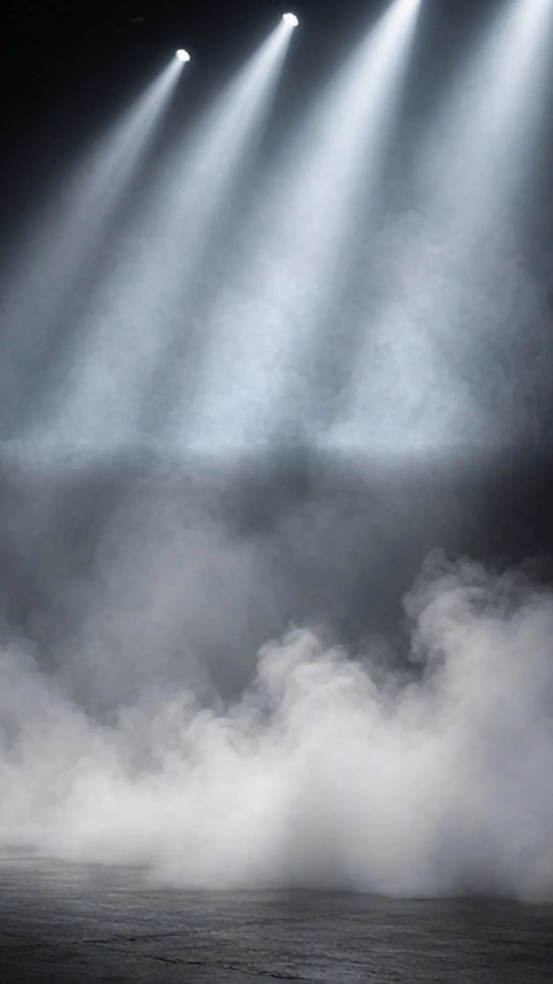 Split scene: dense white fog on the left of a stage