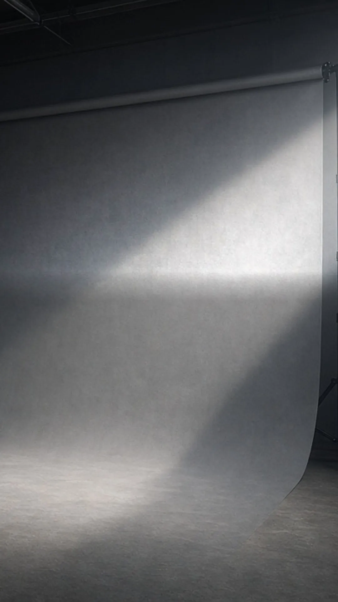 An empty photo studio with a single backdrop